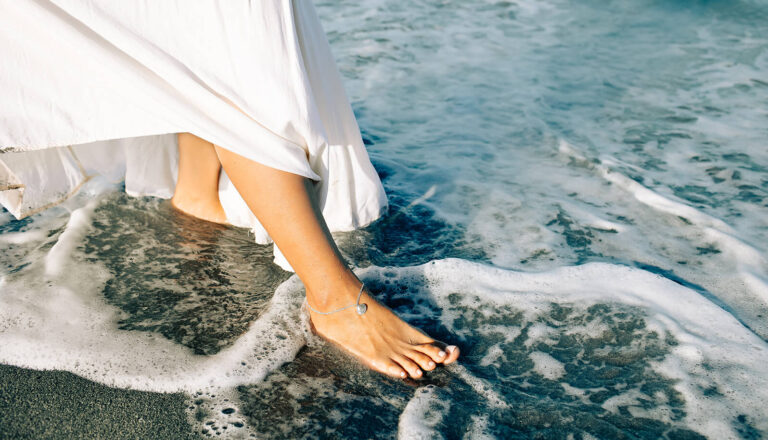woman wearing paradise shells anklet on the beach