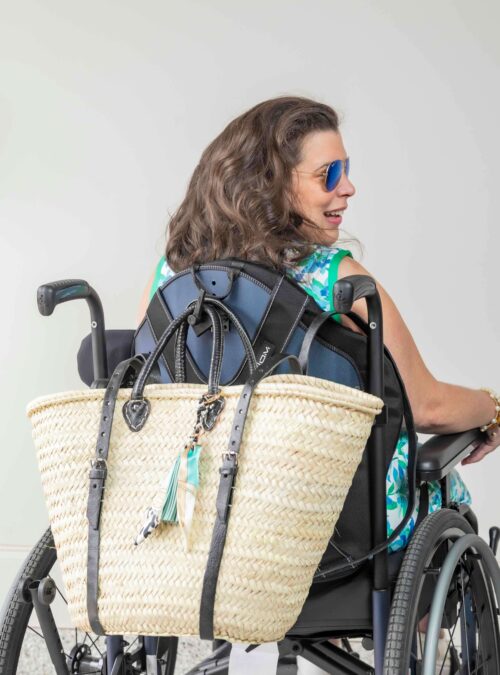 French Market Basket Backpack in Natural/Black on Samantha's wheelchair