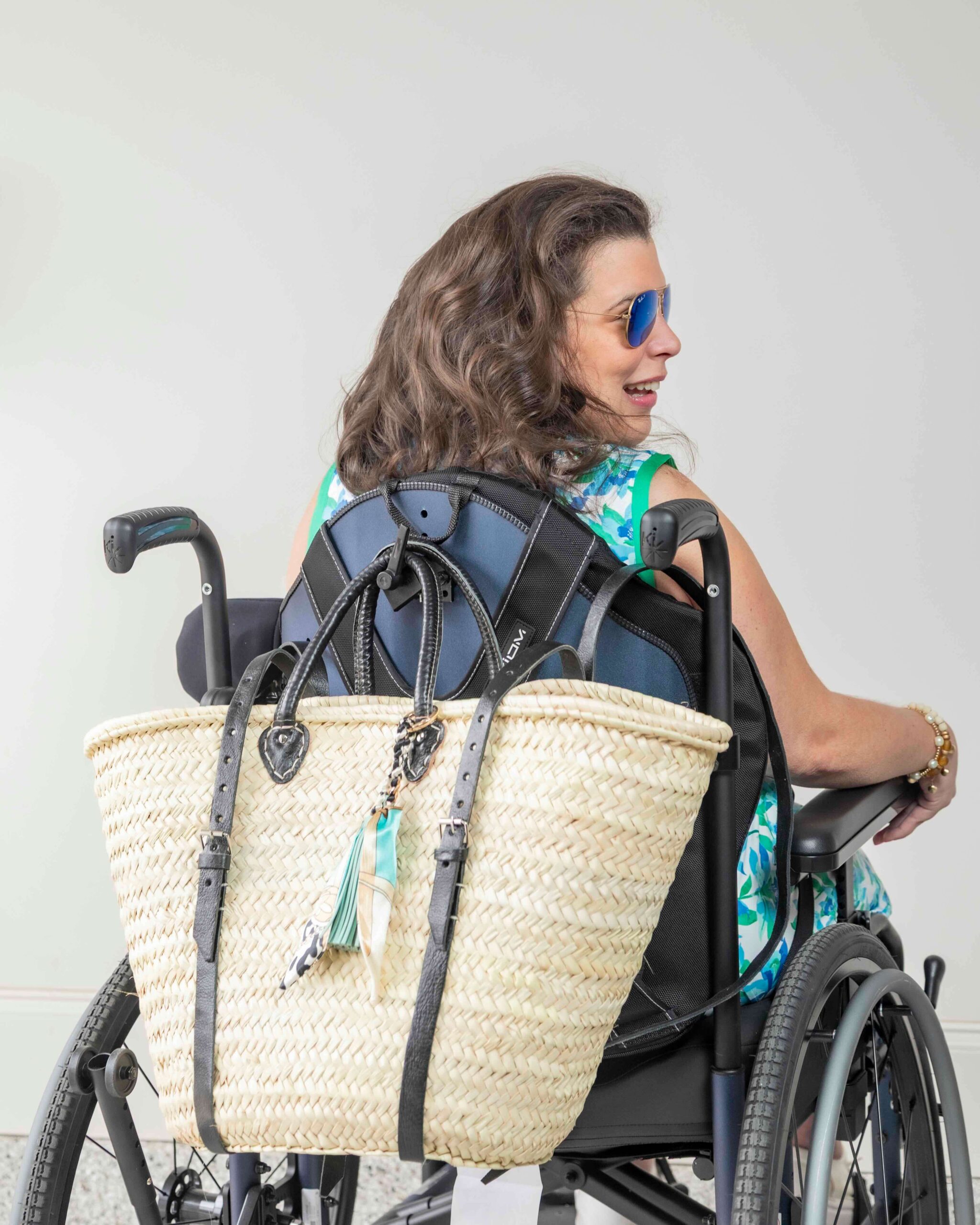 French Market Basket Backpack in Natural/Black on Samantha's wheelchair