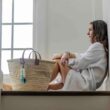 French Market Basket Bag in Natural with model sitting